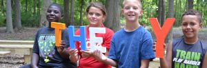 Kids holding the letters at Summer Camp