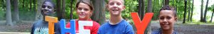 Four children smiling at Summer Camp