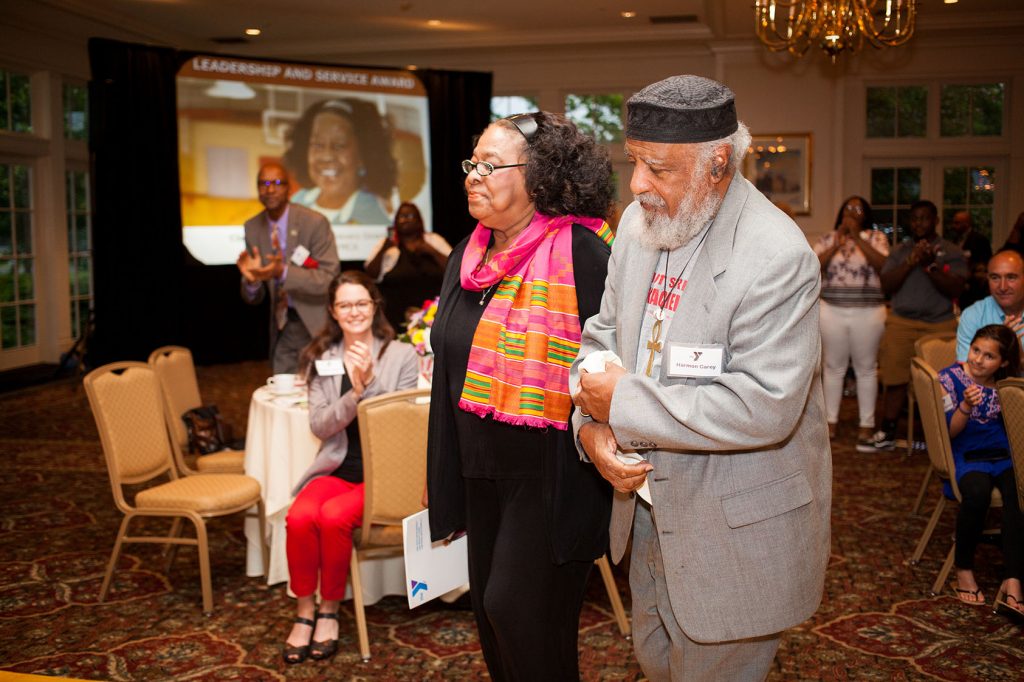 Claire Carey, Black Achievers Director, was escorted to the stage by her husband to accept the Leadership and Service Award.