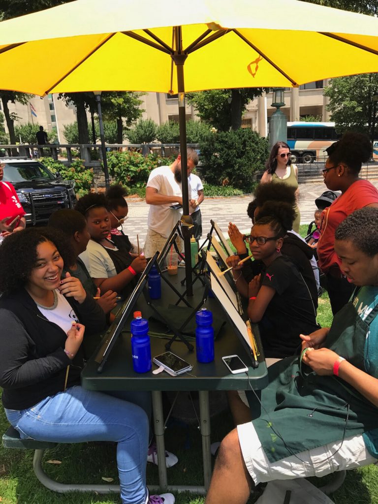 Central YMCA participants painting in Rodney Square.