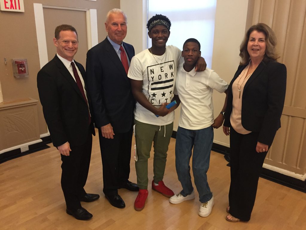 Attorney General Matt Denn, Mayor of Wilmington Mike Purzycki, TAKE ON SUMMER participants Kemuel Harding and his brother Kassel, and the Y of Delaware CEO Deborah Bagatta-Bowles, stop to pose for a photo after the press conference.