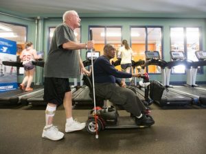 Two Men Helping One Another at Gym