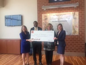 Leadership Holding Wells Fargo Donation Check